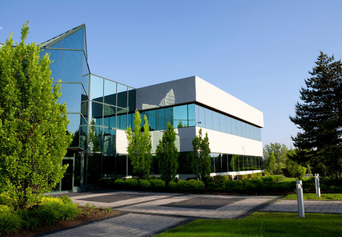 office building surrounded by trees and landscaping